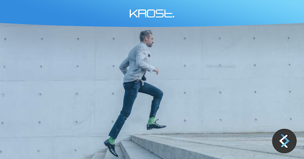 Man running up stairs with Krost logo above on a blue banner background
