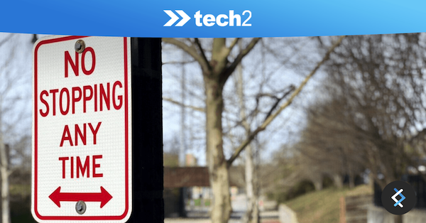 Photo of 'no stopping any time sign' with tech2 logo above it on blue banner background
