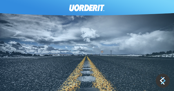 Photograph of a road with clouds above it, UORDERIT logo above in white on a blue banner background